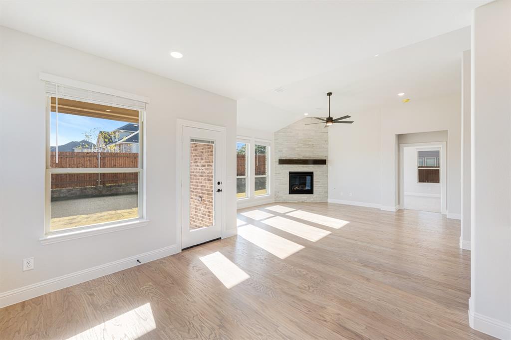 2505 Rileigh Lane Mansfield, TX 76063 - Photo 15 of 40 a view of empty room with wooden floor and fireplace