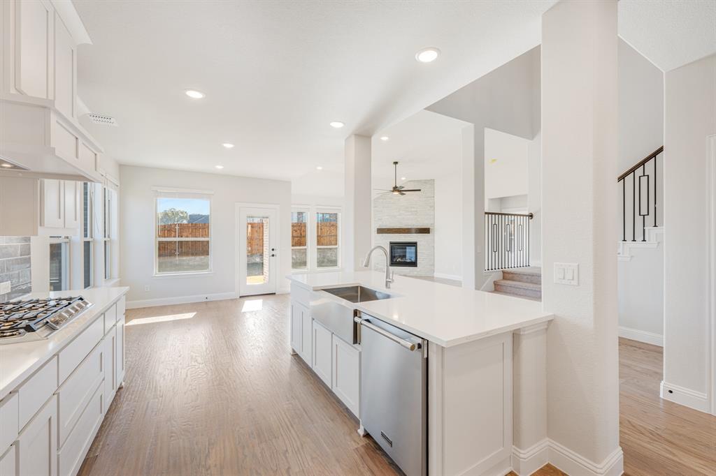 2505 Rileigh Lane Mansfield, TX 76063 - Photo 17 of 40 a kitchen with granite countertop a sink stove and refrigerator