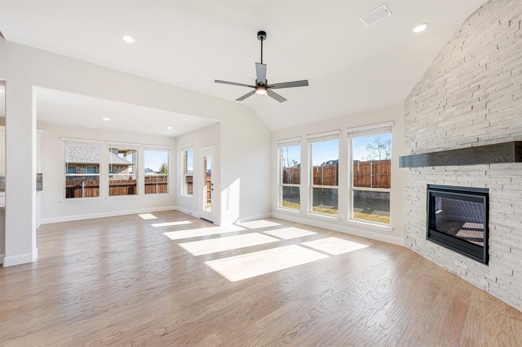 2505 Rileigh Lane Mansfield, TX 76063 - Photo 18 of 40 a view of a livingroom with wooden floor a fireplace and window