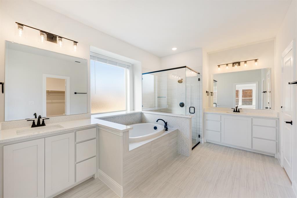 2505 Rileigh Lane Mansfield, TX 76063 - Photo 22 of 40 a bathroom with a tub a sink a mirror and a shower
