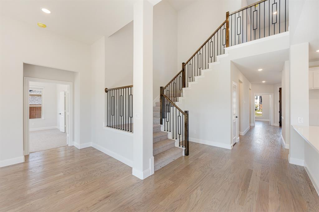 2505 Rileigh Lane Mansfield, TX 76063 - Photo 24 of 40 a view of a hallway with wooden floor and staircase