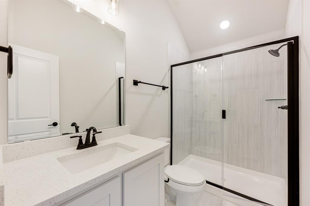 2505 Rileigh Lane Mansfield, TX 76063 - Photo 36 of 40 a bathroom with a sink a toilet and a large mirror