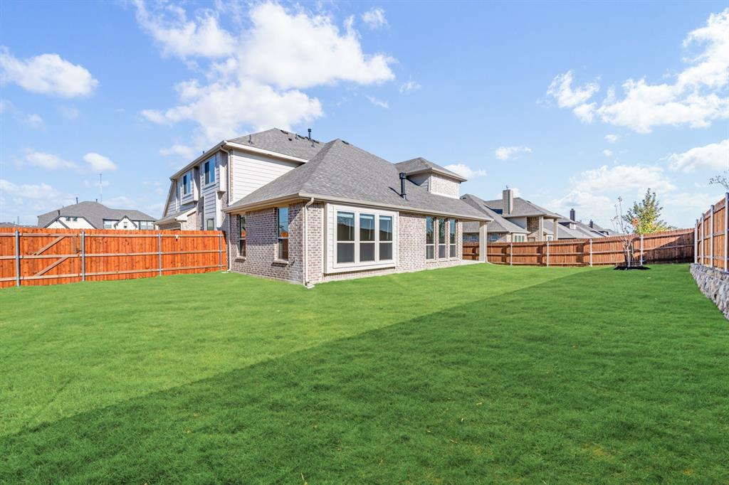 2505 Rileigh Lane Mansfield, TX 76063 - Photo 38 of 40 a front view of a house with a garden