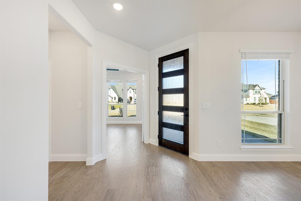 2505 Rileigh Lane Mansfield, TX 76063 - Photo 4 of 40 an empty room with windows and wooden floor