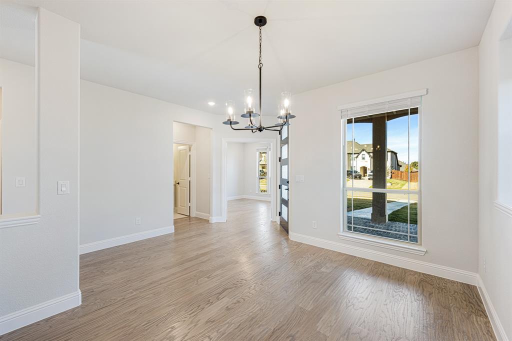 2505 Rileigh Lane Mansfield, TX 76063 - Photo 5 of 40 a view of a room with wooden floor chandelier and windows