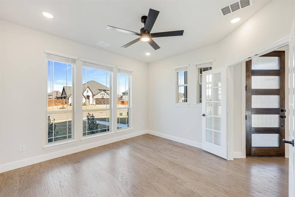 2505 Rileigh Lane Mansfield, TX 76063 - Photo 9 of 40 a view of an empty room with a window and wooden floor