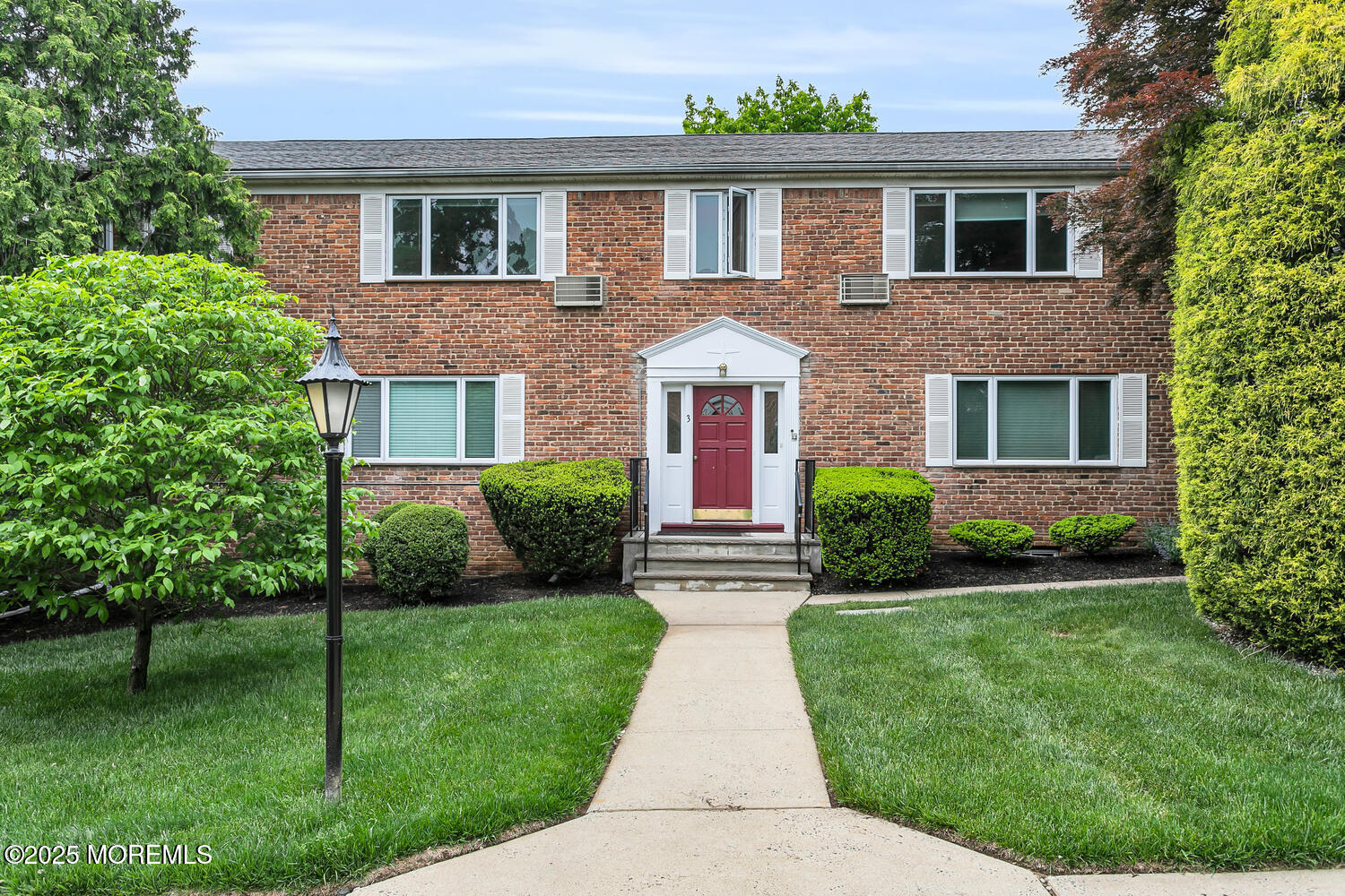 283 Spring Street, Unit 3C Red Bank, NJ 07701 - Photo 18 of 26 a front view of a house with a yard
