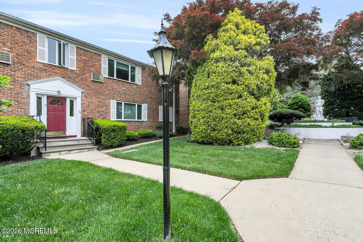 283 Spring Street, Unit 3C Red Bank, NJ 07701 - Photo 4 of 26 a view of a house with a yard and plants