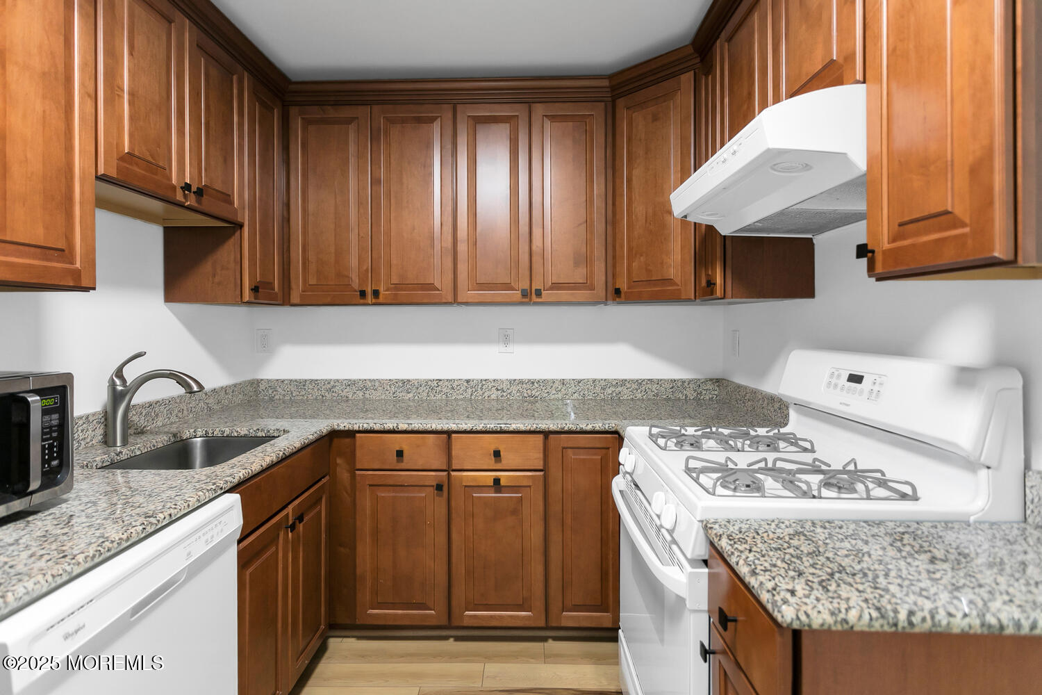 283 Spring Street, Unit 3C Red Bank, NJ 07701 - Photo 7 of 26 a kitchen with granite countertop cabinets and window