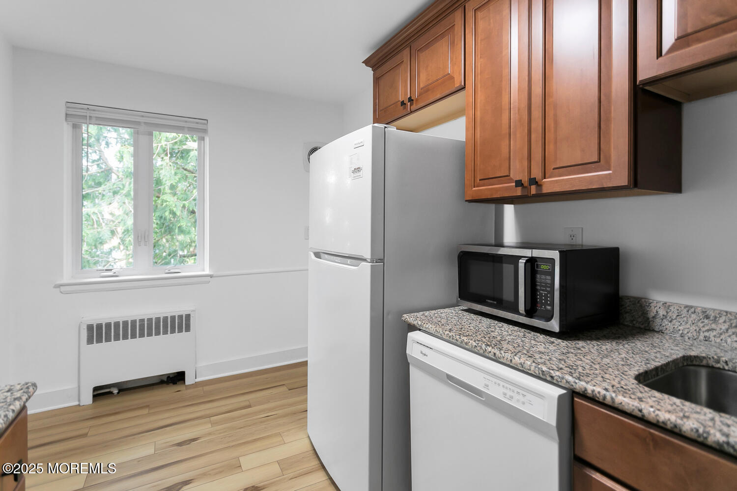 283 Spring Street, Unit 3C Red Bank, NJ 07701 - Photo 9 of 26 a kitchen with stainless steel appliances granite countertop a refrigerator and a sink