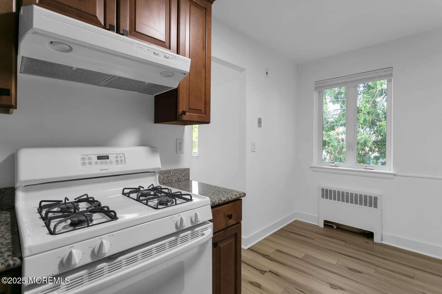 283 Spring Street, Unit 3C Red Bank, NJ 07701 - Photo 10 of 26 a kitchen with a stove and a refrigerator