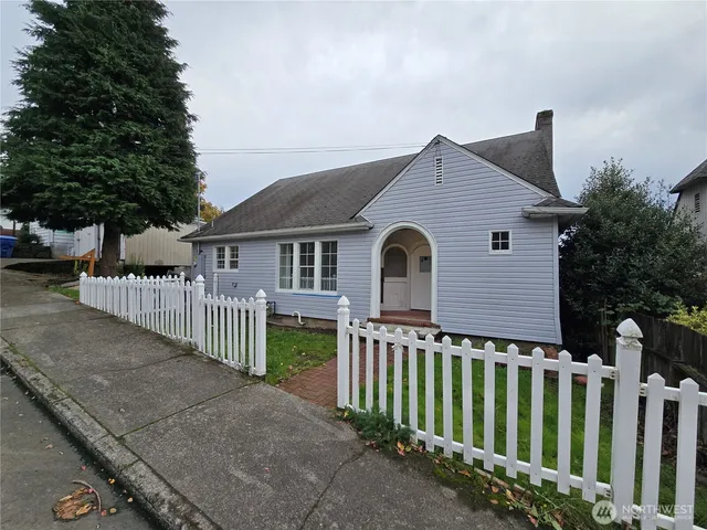 a front view of a house with wooden fence