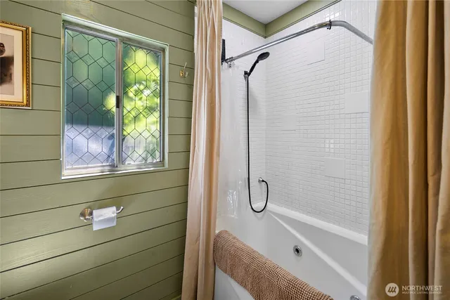a bedroom with a bed table and a potted plant