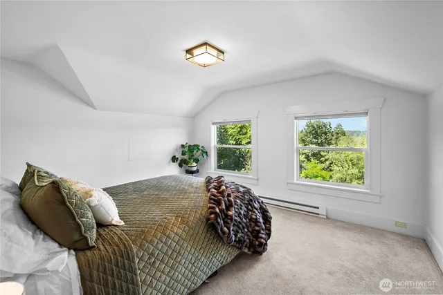 a bedroom with a bed and a table