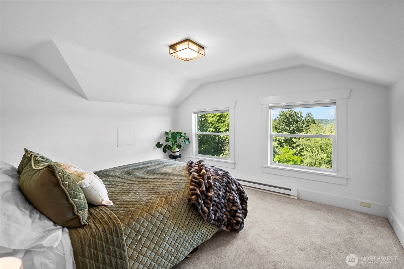 16832 McIntyre Road Southwest Vashon, WA 98070 - Photo 23 of 38 a bed sitting in a bedroom next to a window