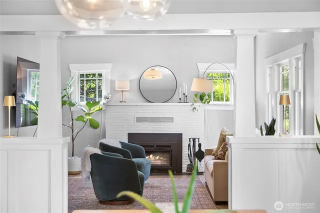 a living room with furniture potted plant and a fireplace