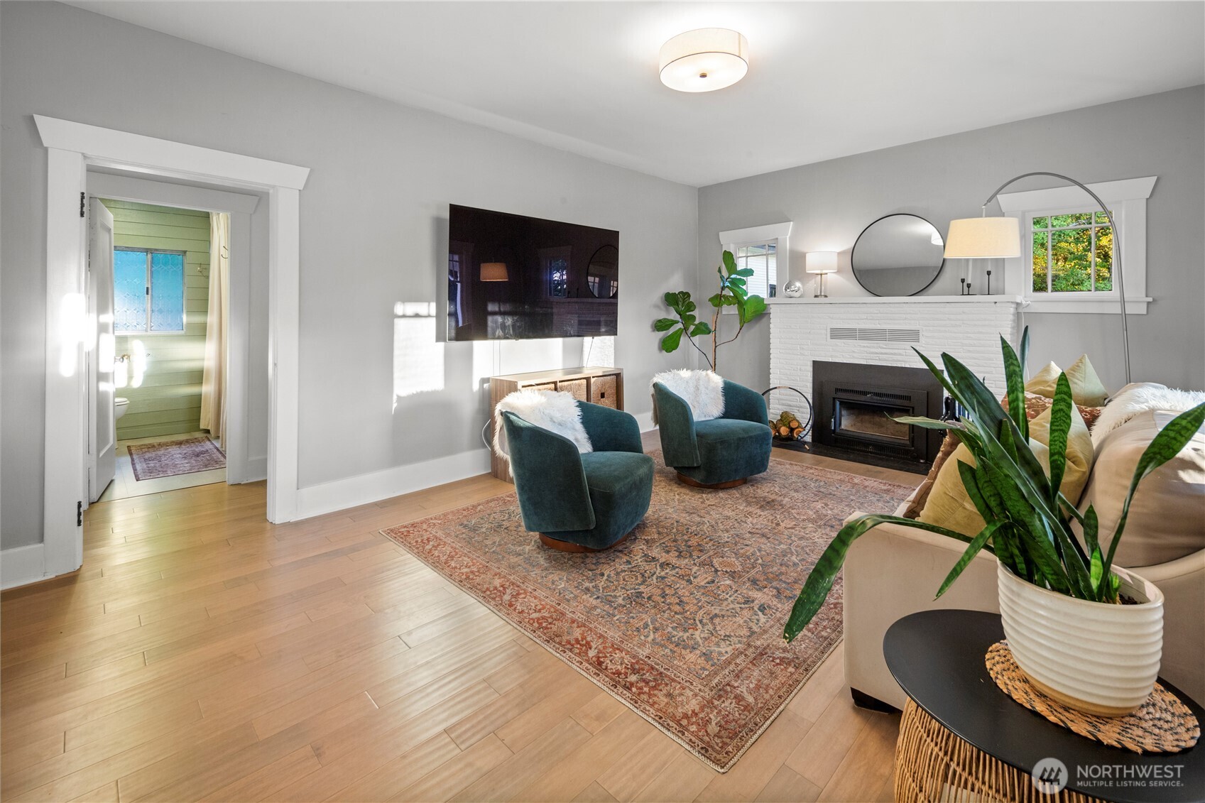 16832 McIntyre Road Southwest Vashon, WA 98070 - Photo 8 of 38 a living room with furniture potted plant and a fireplace