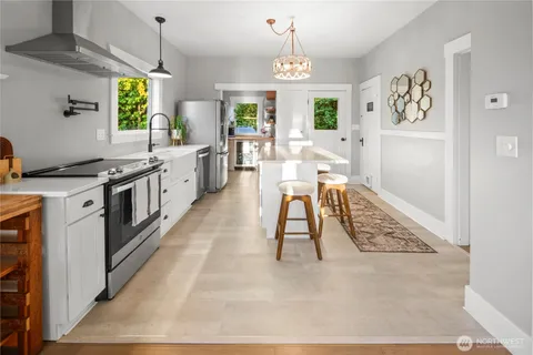 a large white kitchen with a large window