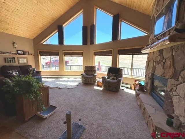 a living room with furniture and a floor to ceiling window