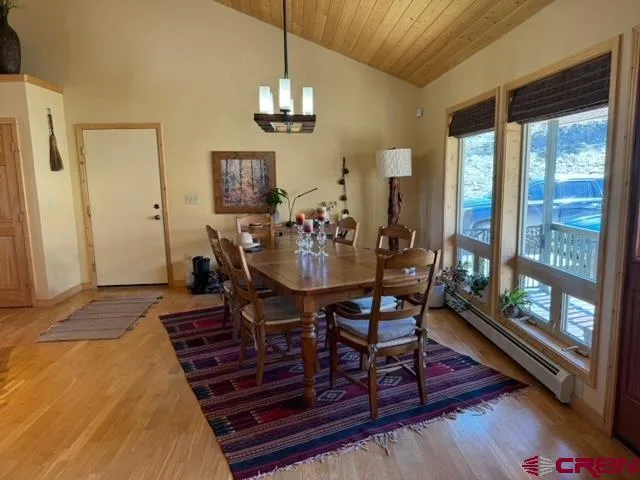 a view of a dining room with furniture wooden floor and chandelier