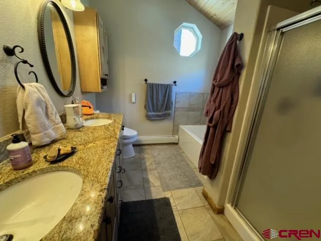 a bathroom with a tub sink and mirror
