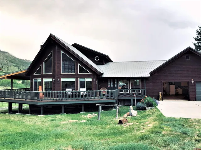 a front view of a house with a yard table and chairs