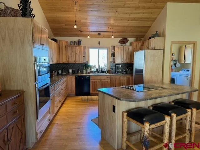 a kitchen with table and chairs
