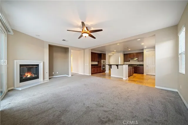a view of an empty room with a fireplace and a window