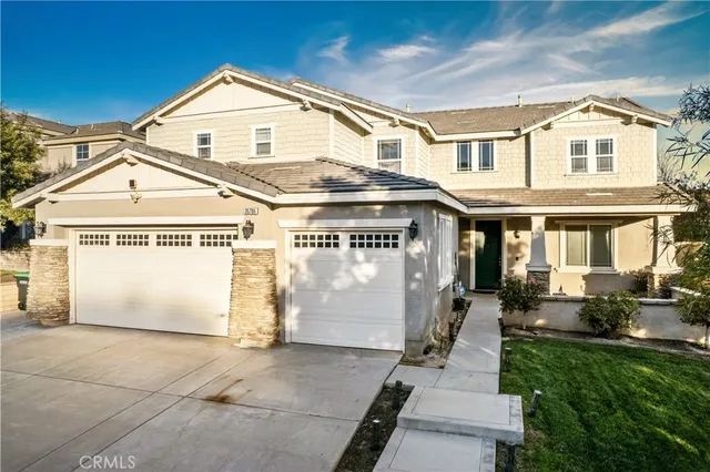 a view of a white house with large windows and a yard