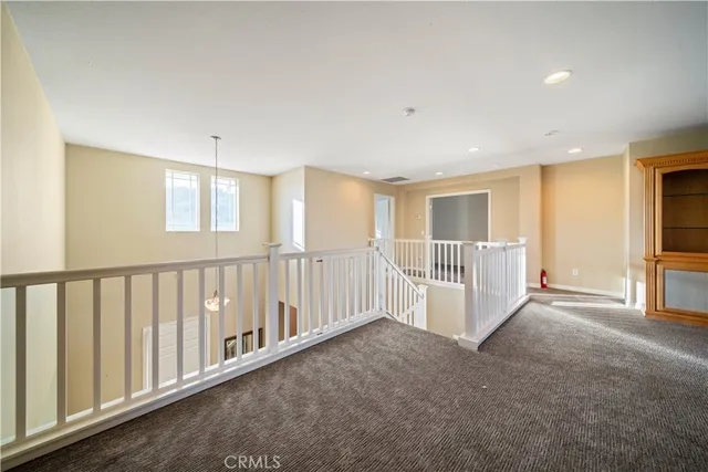 an empty room with window and ceiling fan