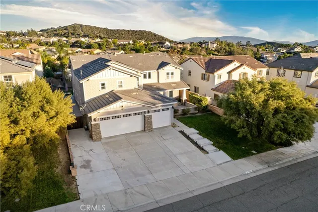 an aerial view of a house with a swimming pool and outdoor seating