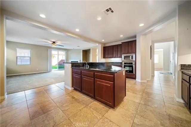 a view of a kitchen with a sink and a fireplace
