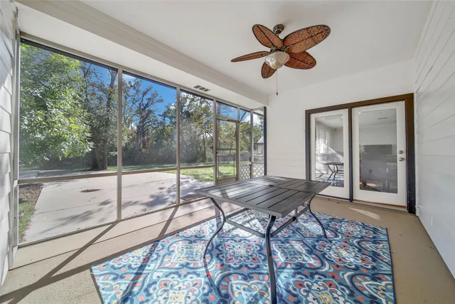 a view of house with a big yard and potted plants