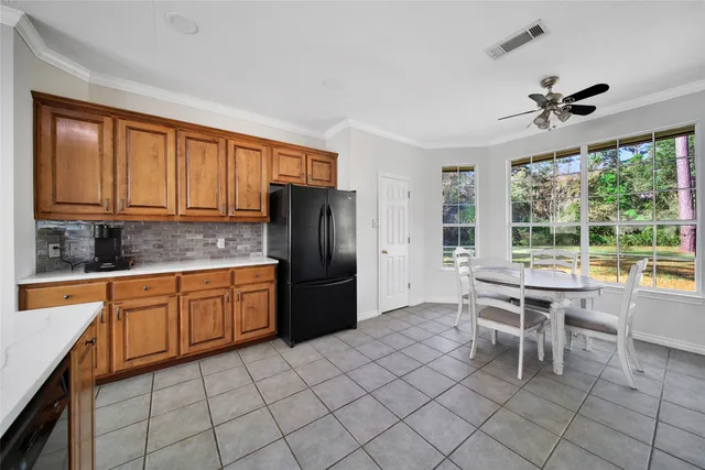 a kitchen with a sink a stove cabinets and a window