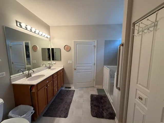 a bathroom with a double vanity sink and a mirror
