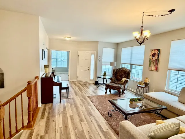 a living room with furniture a couch and a chandelier