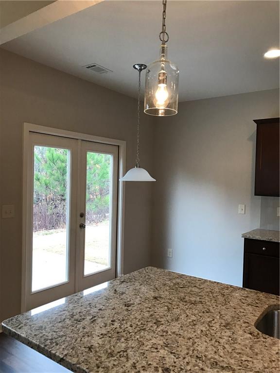 5934 Watersdown Way Flowery Branch, GA 30542 - Photo 11 of 28 a view of a bedroom with a bed and wooden floor