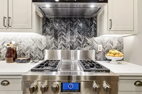 a kitchen with a stove and cabinets