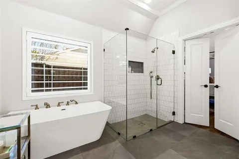 a bathroom with a bathtub and a shower