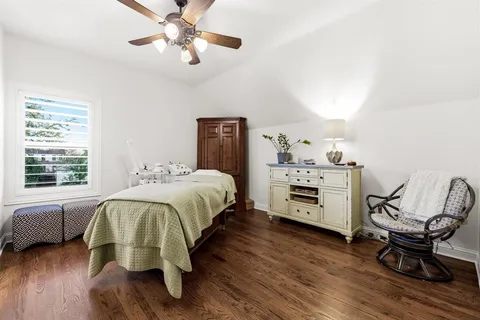 a bed room with a bed and a chair