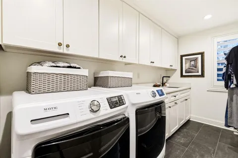 a kitchen with a stove and a white cabinets