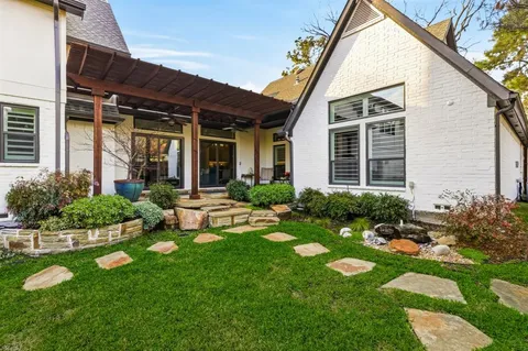 a view of a house with backyard sitting area and garden