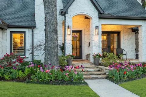 a view of a house with potted plants