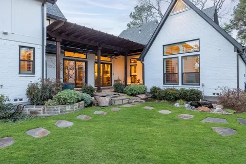 a view of a house with backyard and sitting area