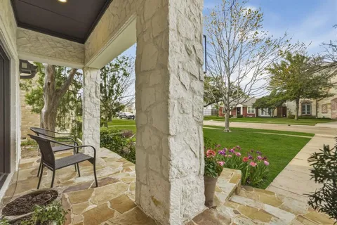 a view of a porch with furniture and garden