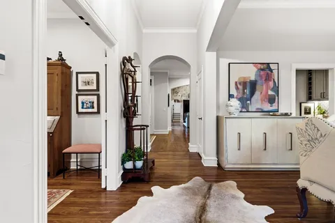 a living room with furniture and painting on the wall