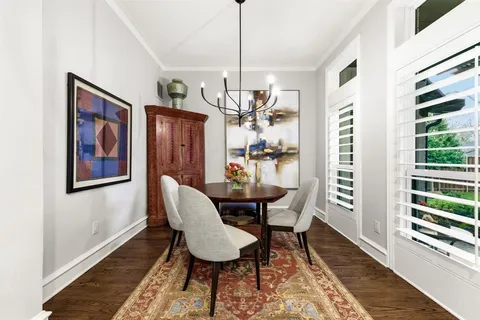 a dining room with furniture a rug and wooden floor