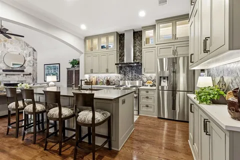 a kitchen with appliances cabinets and furniture
