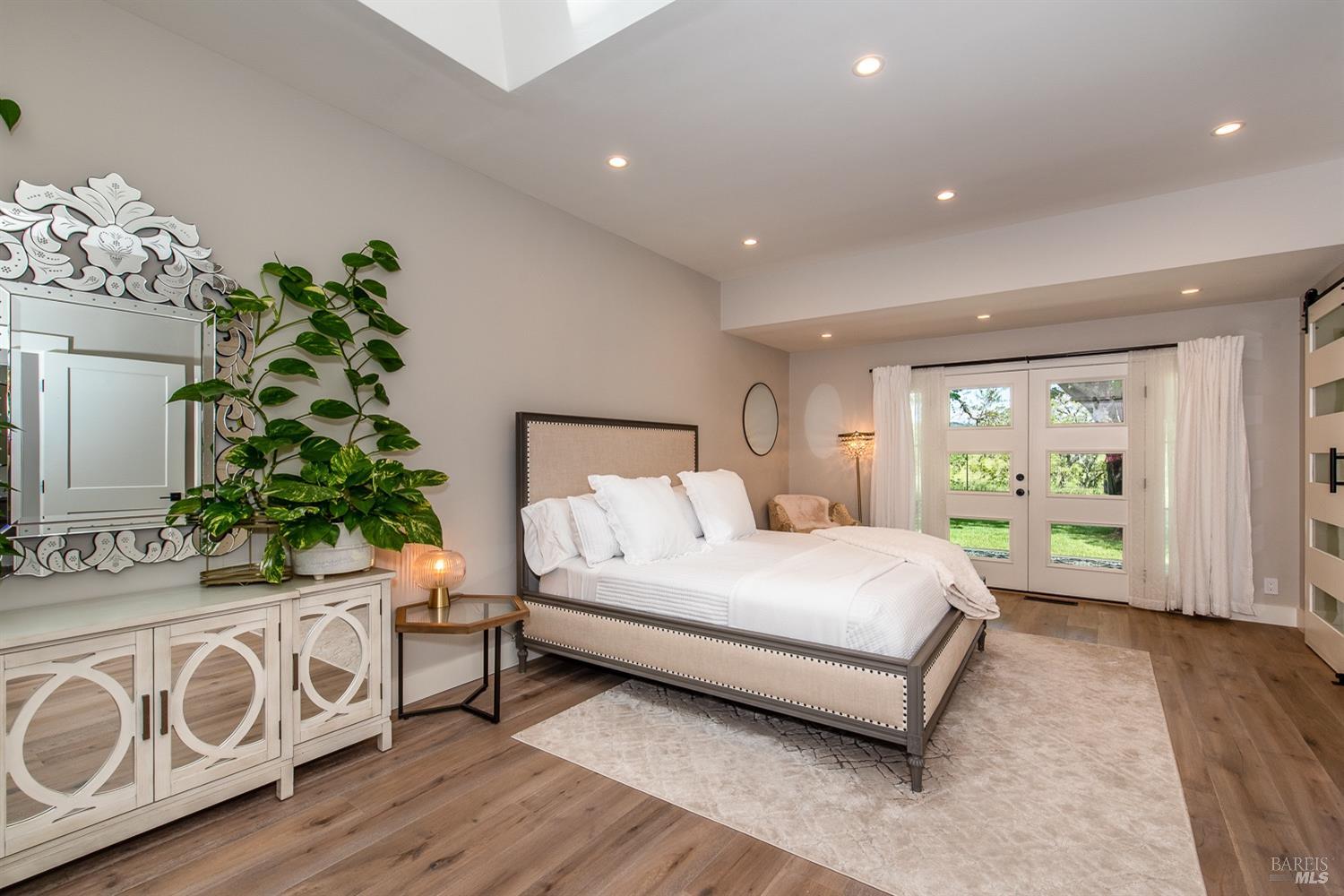 4193 Sonoma Mountain Road Santa Rosa, CA 95404 - Photo 1 of 1 a bedroom with a bed table flowerpot and window