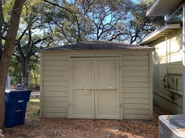 a view of a door of the house and a yard